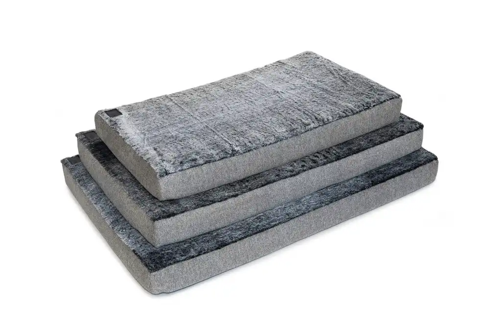 Stack of Arctic Faux Fur Superior Ortho Dog Mats in multiple sizes