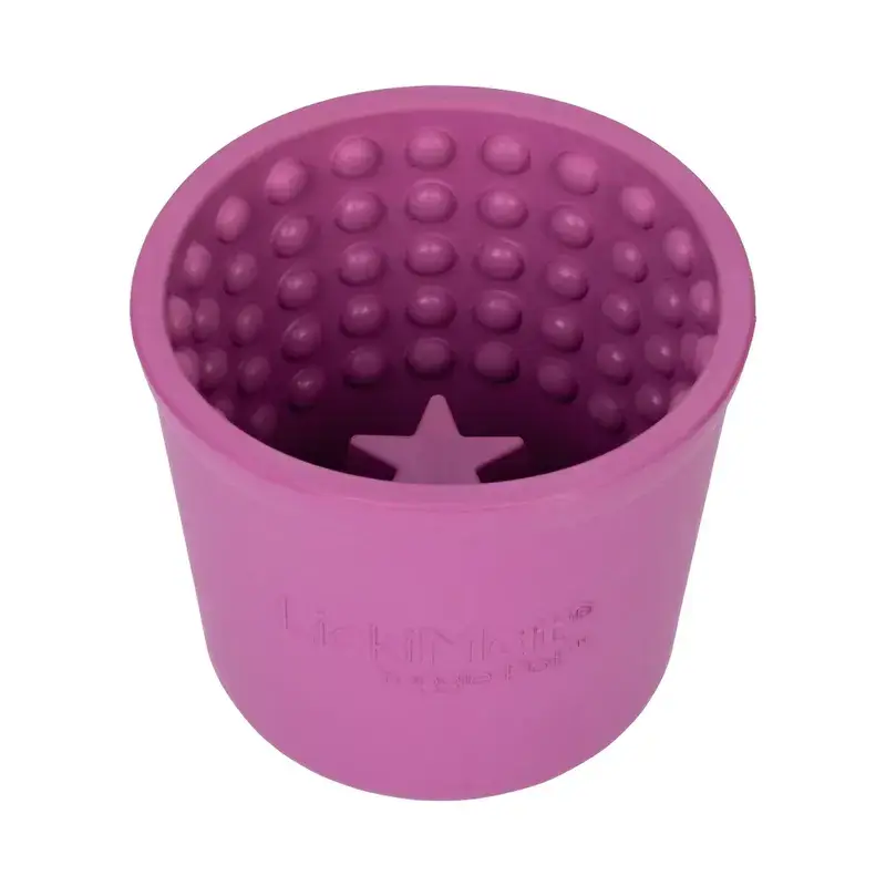 Purple LickiMat Yoggie Pot slow feeder cup with textured interior for dogs.