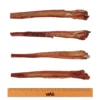 WAG Bully Sticks Size Comparison Four WAG Bully Sticks for dogs laid out with a ruler underneath for size comparison, showing natural variation in length and shape.