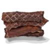 Blackdog Beef Jerky Dog Treats – Flat Jerky Pieces Flat pieces of Blackdog beef jerky dog treats stacked on a black background.
