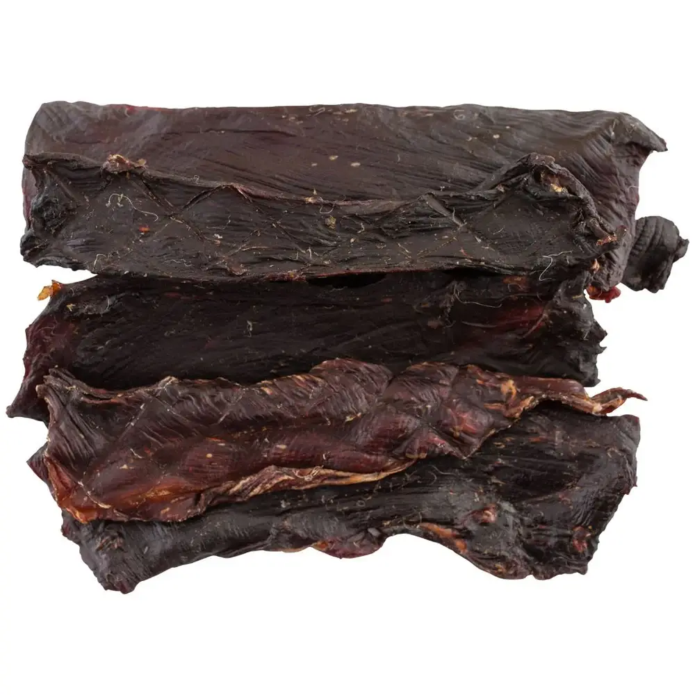 A pile of dried kangaroo jerky dog treat strips showing their dark, textured surface.