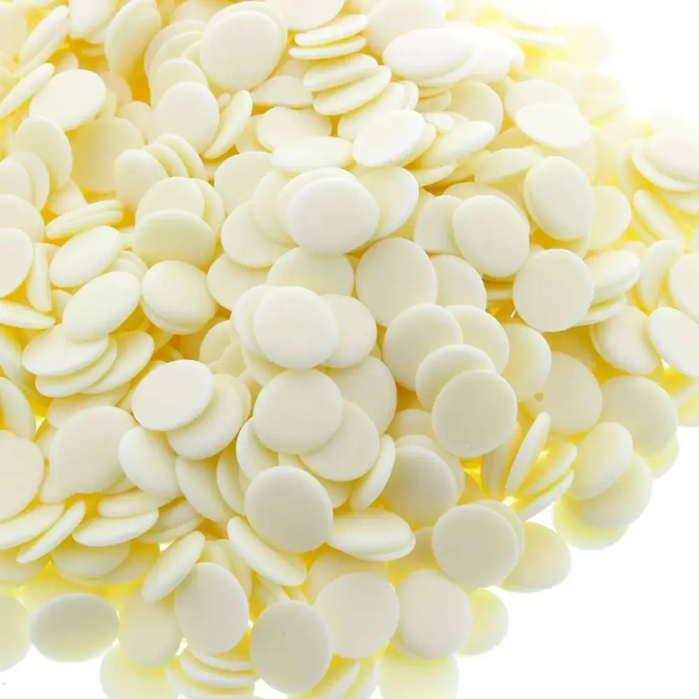 Large mound of white yoghurt dog treat buttons on a white background.