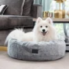Superior Harley Dog Bed Arctic Faux Fur Lifestyle White dog relaxing in a Superior Harley dog bed in arctic faux fur in a modern living room