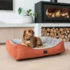 Small dog relaxing in a Superior Ortho Haven dog bed in a modern living room